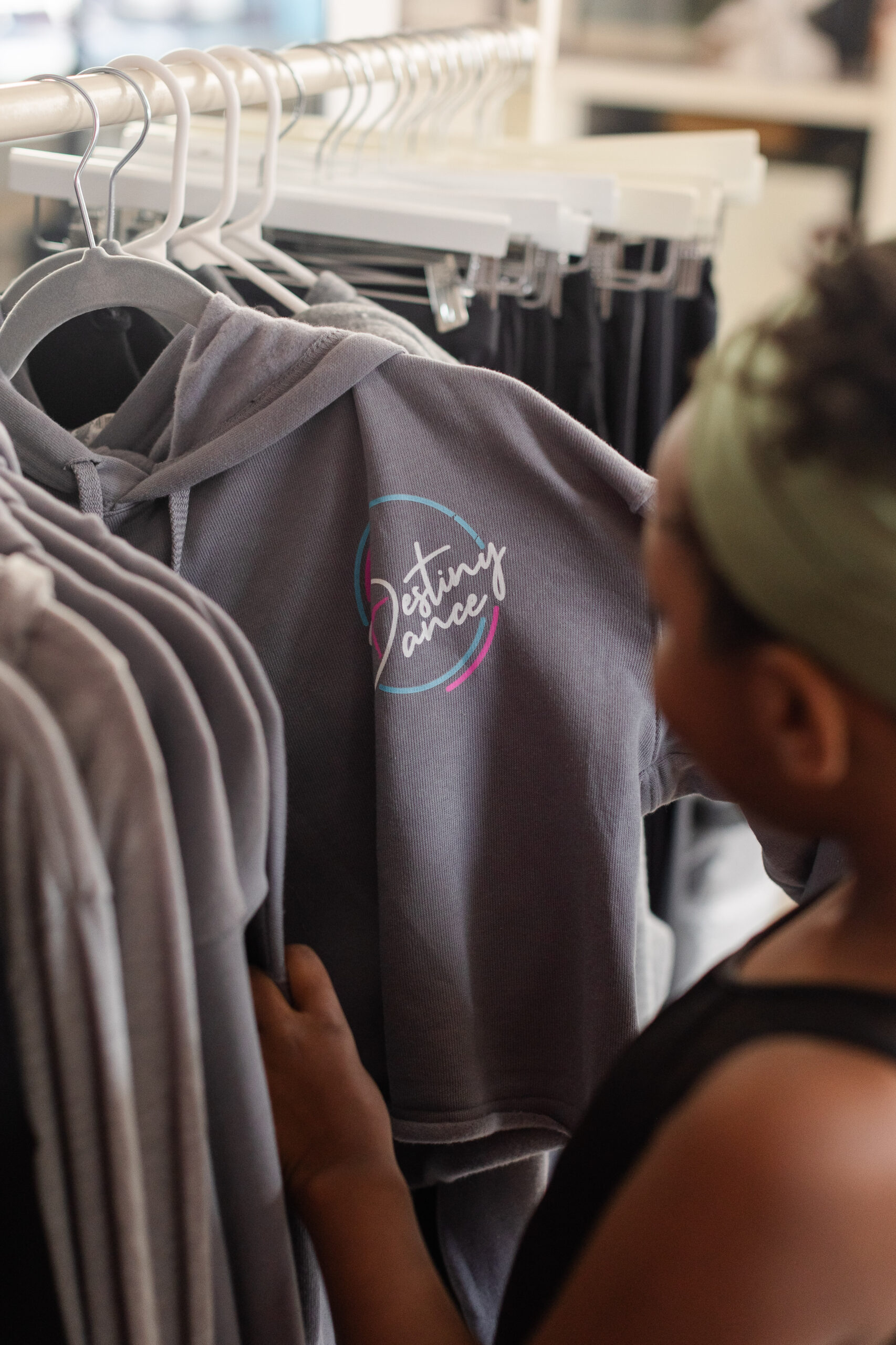 A student browses Destiny Dance merchandise in the studio shop