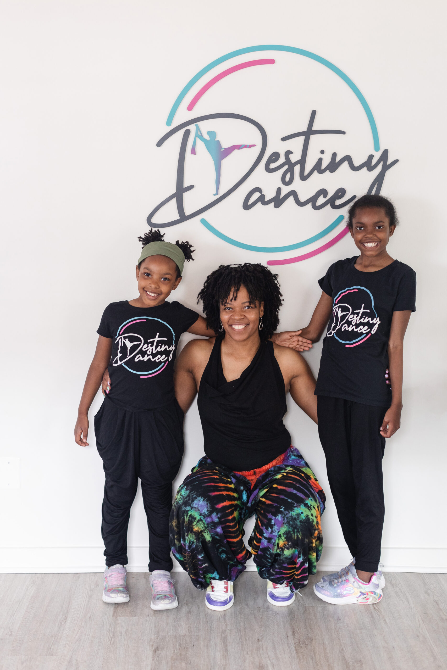 Ms April, founder of Destiny Dance, poses with her two daughters, both enrolled in Destiny Dance
