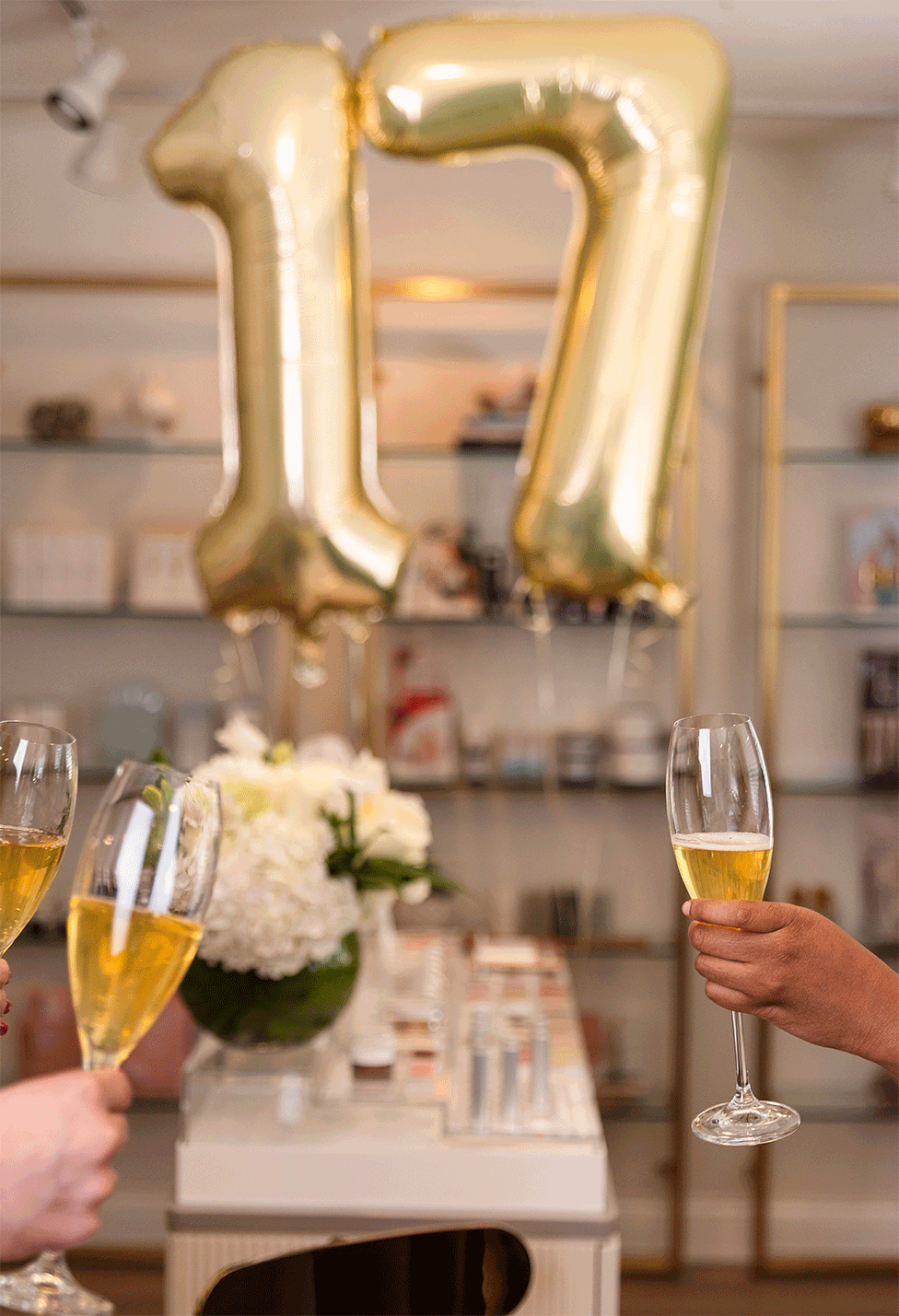 animated gif of 3 glasses of champagne toasting in front of balloons in the shape of the number 17 to celebrate Sesen Spa's anniversary
