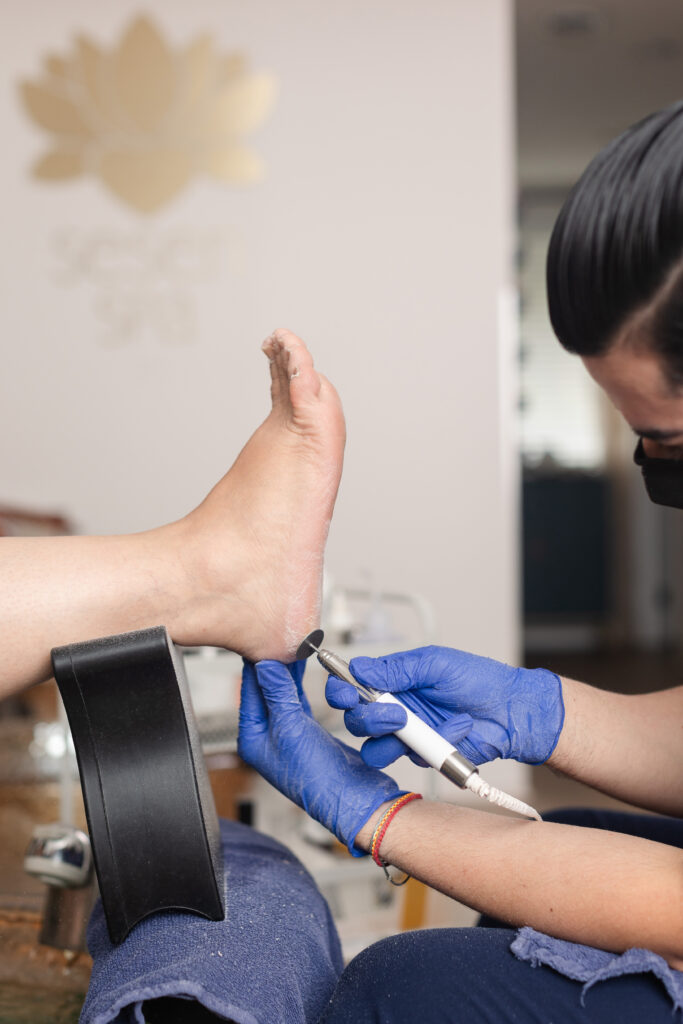 a side shot of a paramedical pedicure being performed, with the Sesen Spa logo in the background