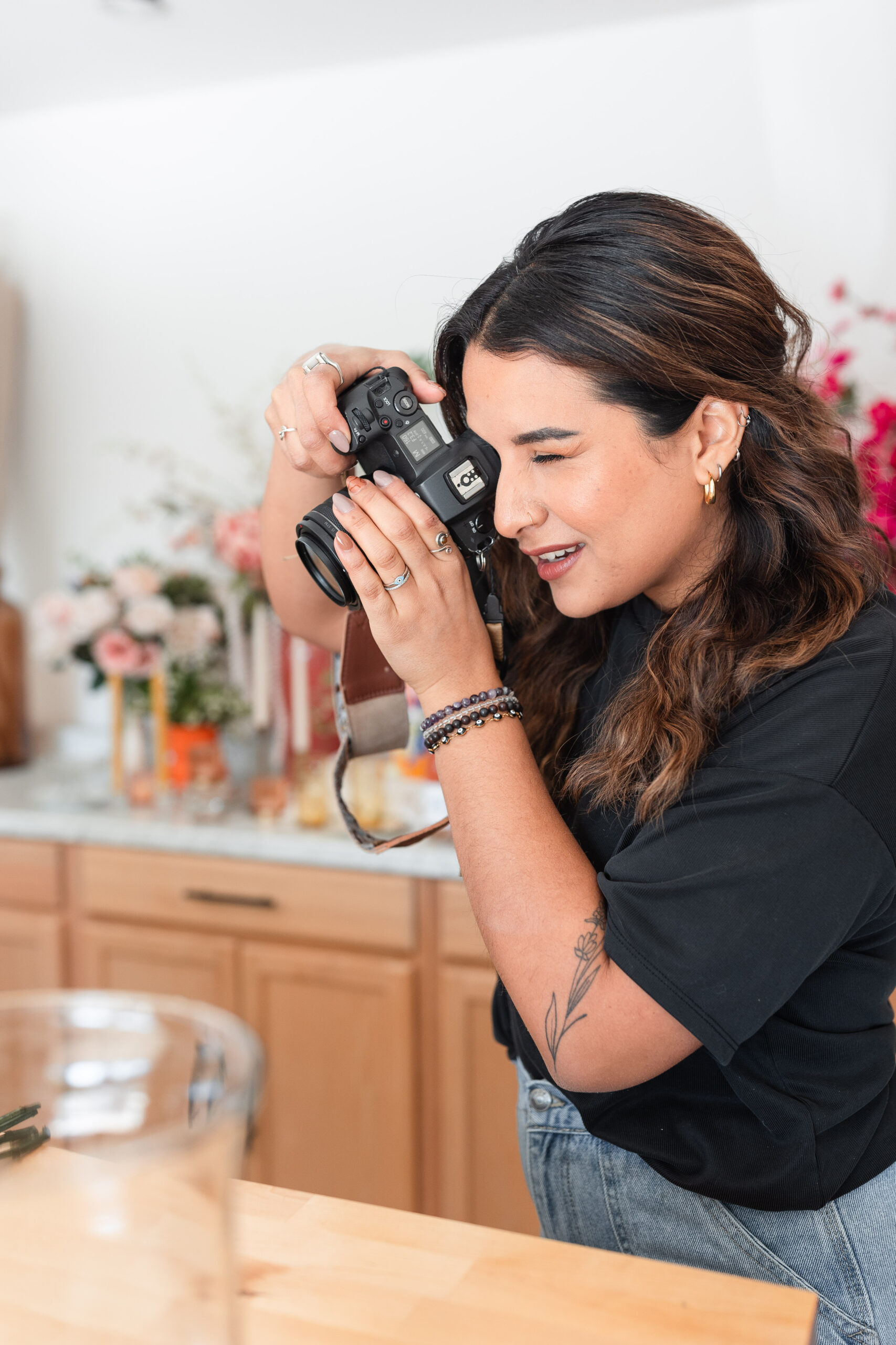 a latina photographer taking photos on set for a client branding session