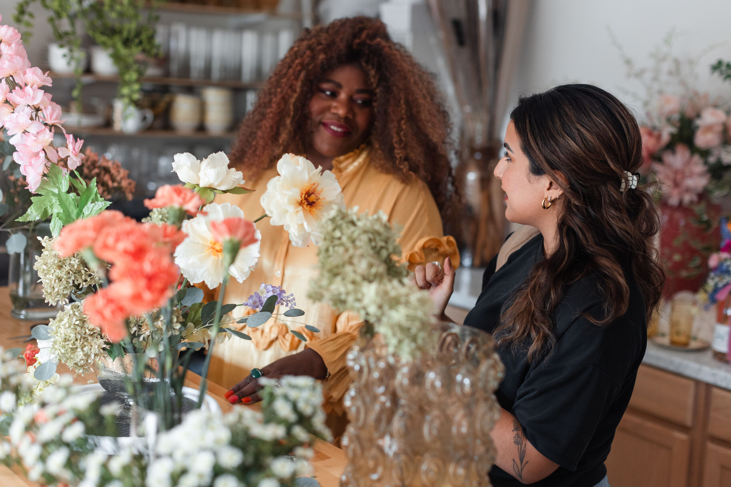 a latina photographer consults with her wedding florist client's branding session