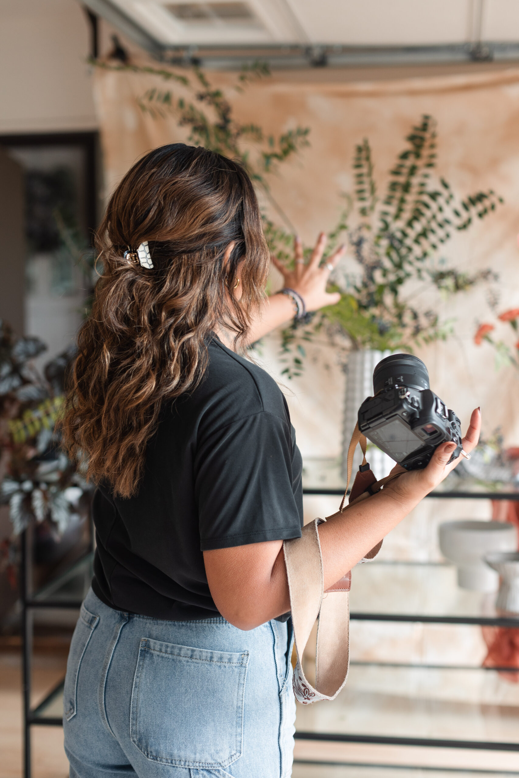 a latina photographer directs during a wedding florist's branding session