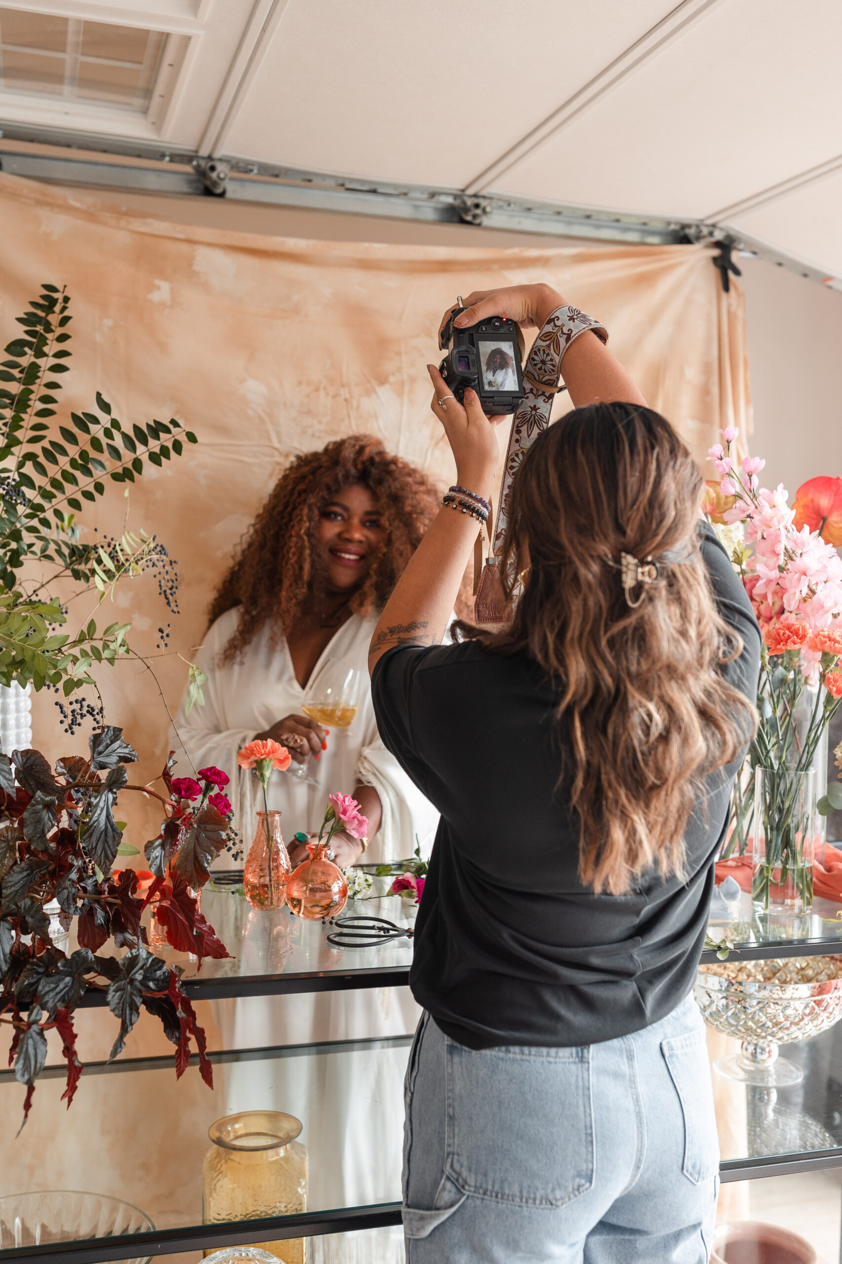 a latina photographer takes photos for a wedding florist's branding session