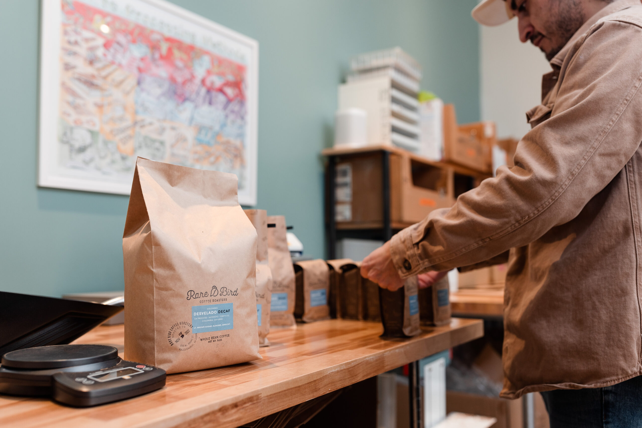 A coffee roaster seals bags of house-roasted coffee at Rare Bird Coffee Roasters in Falls Church City, Virginia
