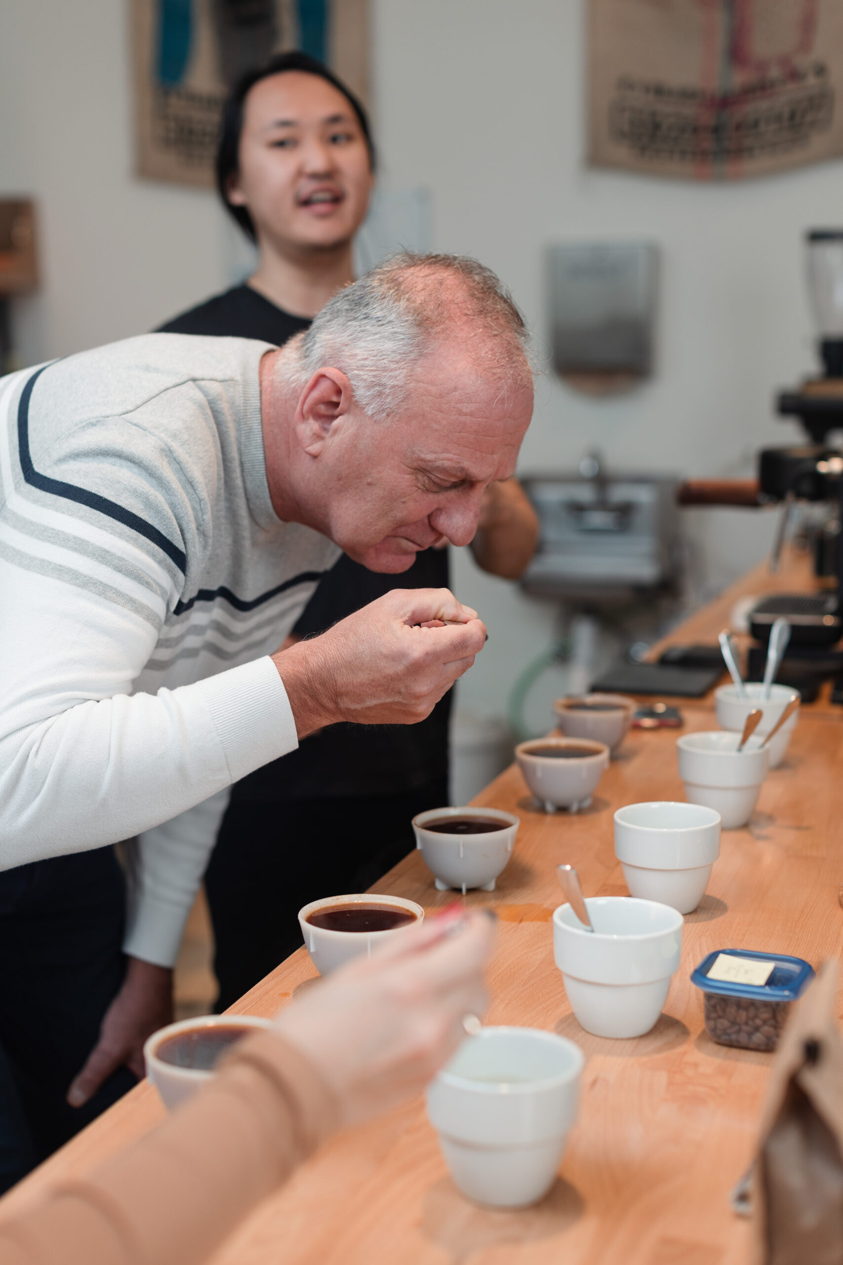 A man samples coffee during a cupping class