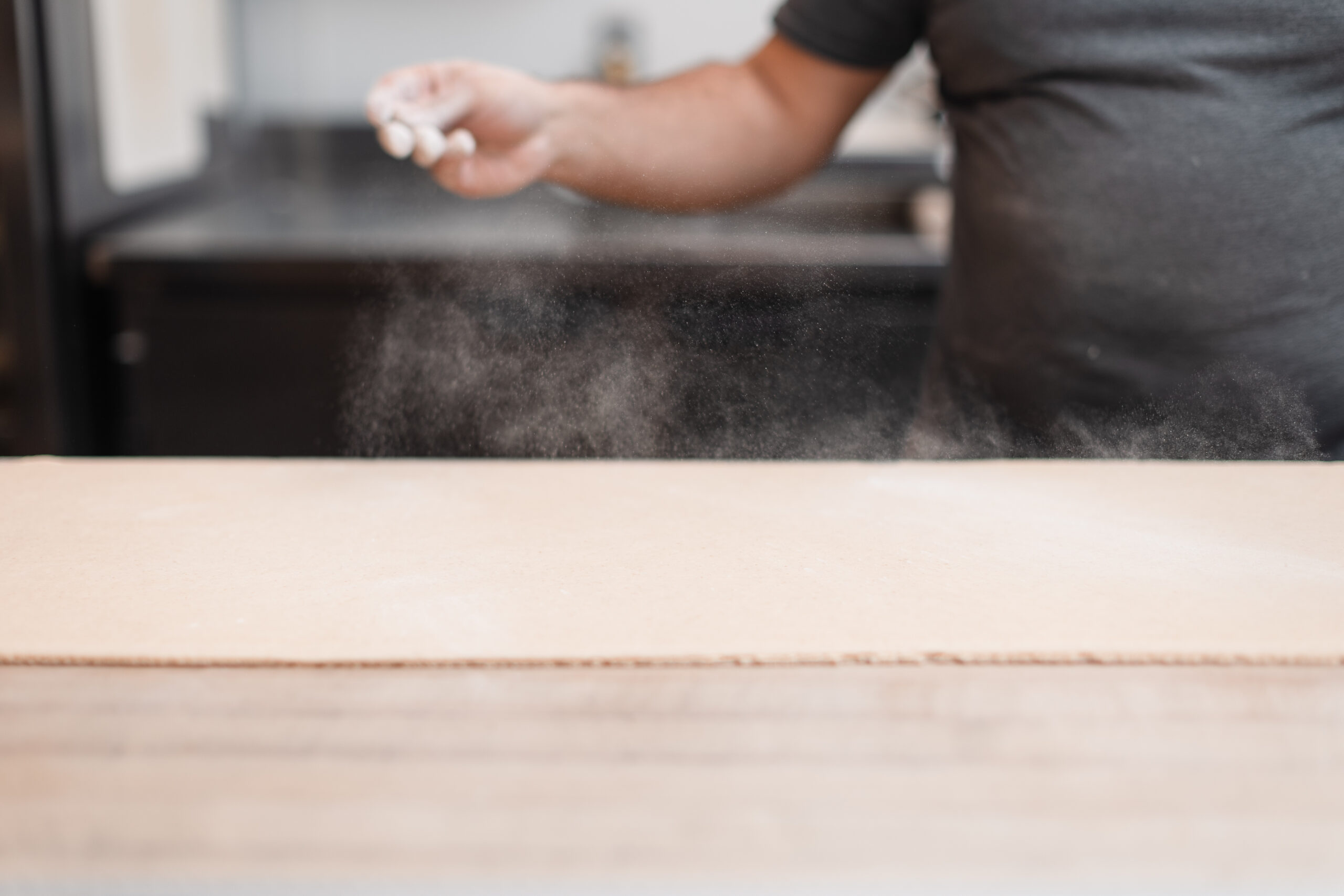 Flour is sprinkled over rolled out dough