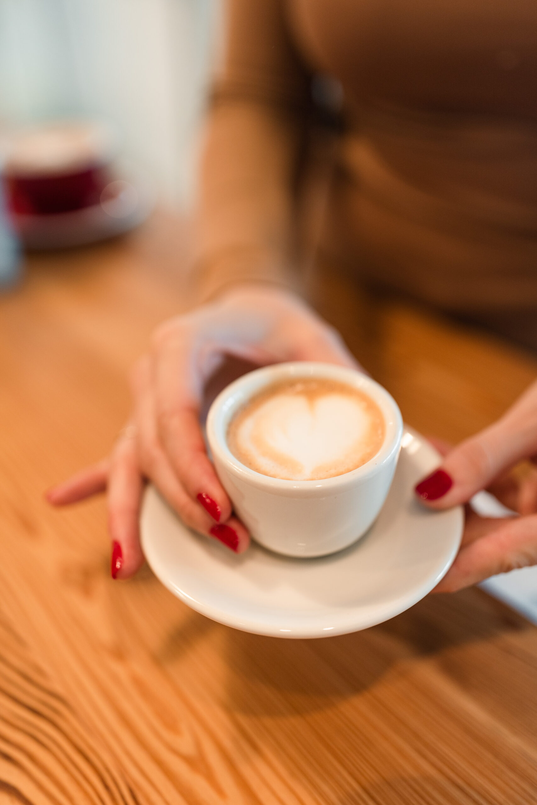 A woman holds her perfect double shot of espresso