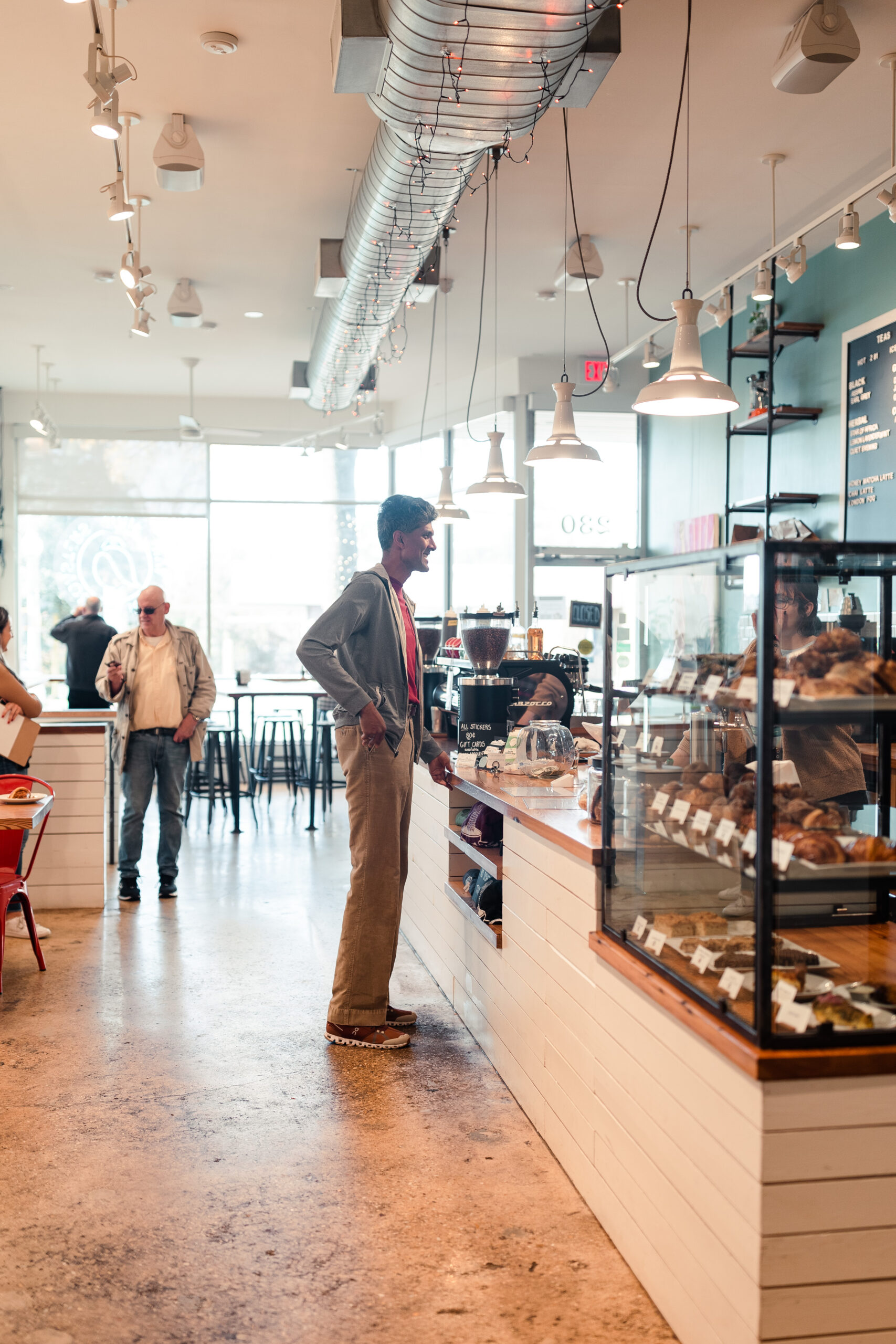 A man smiles while placing his order at Rare Bird Coffee Roasters in Falls Church City, Virginia