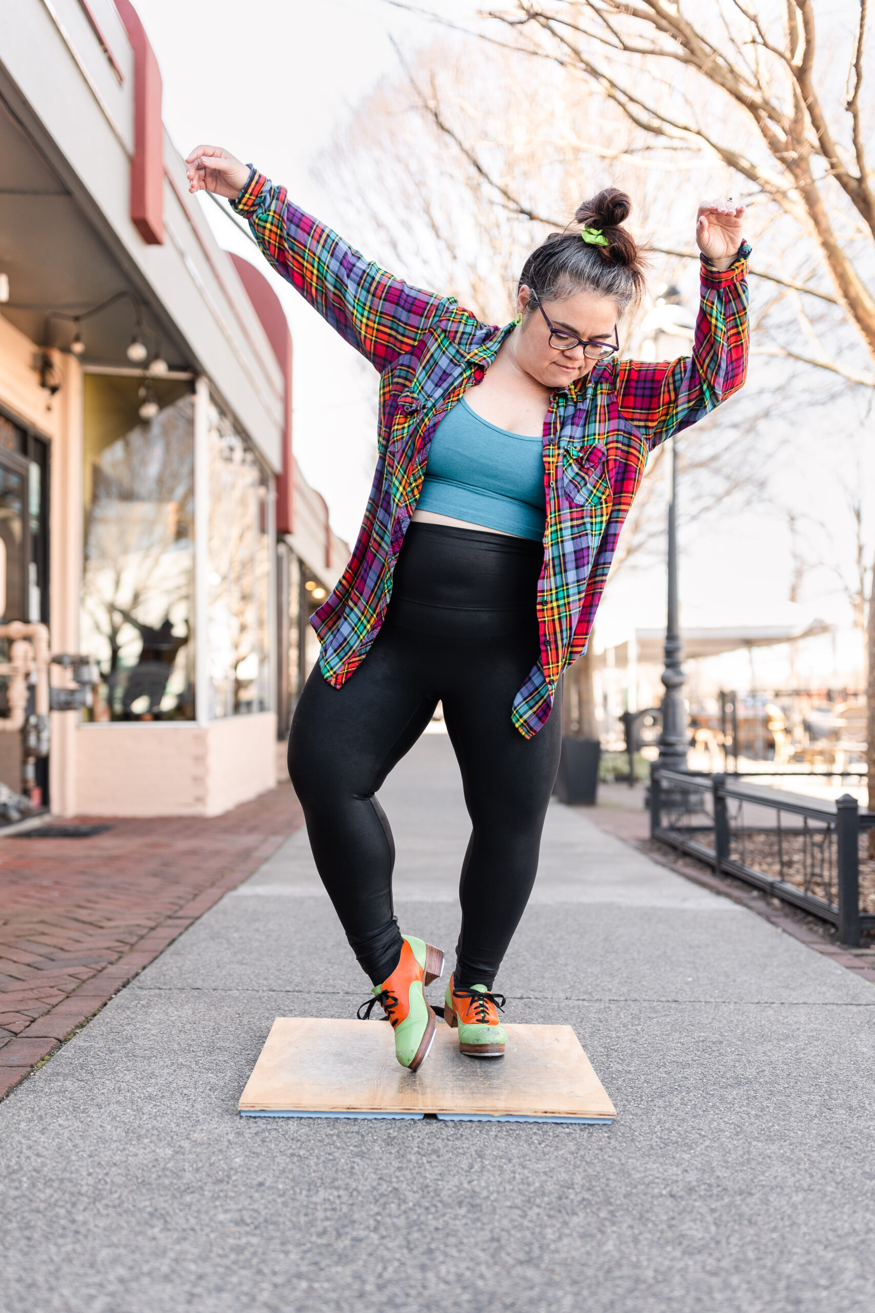 tap dancer and educator joyfully dances on the sidewalk