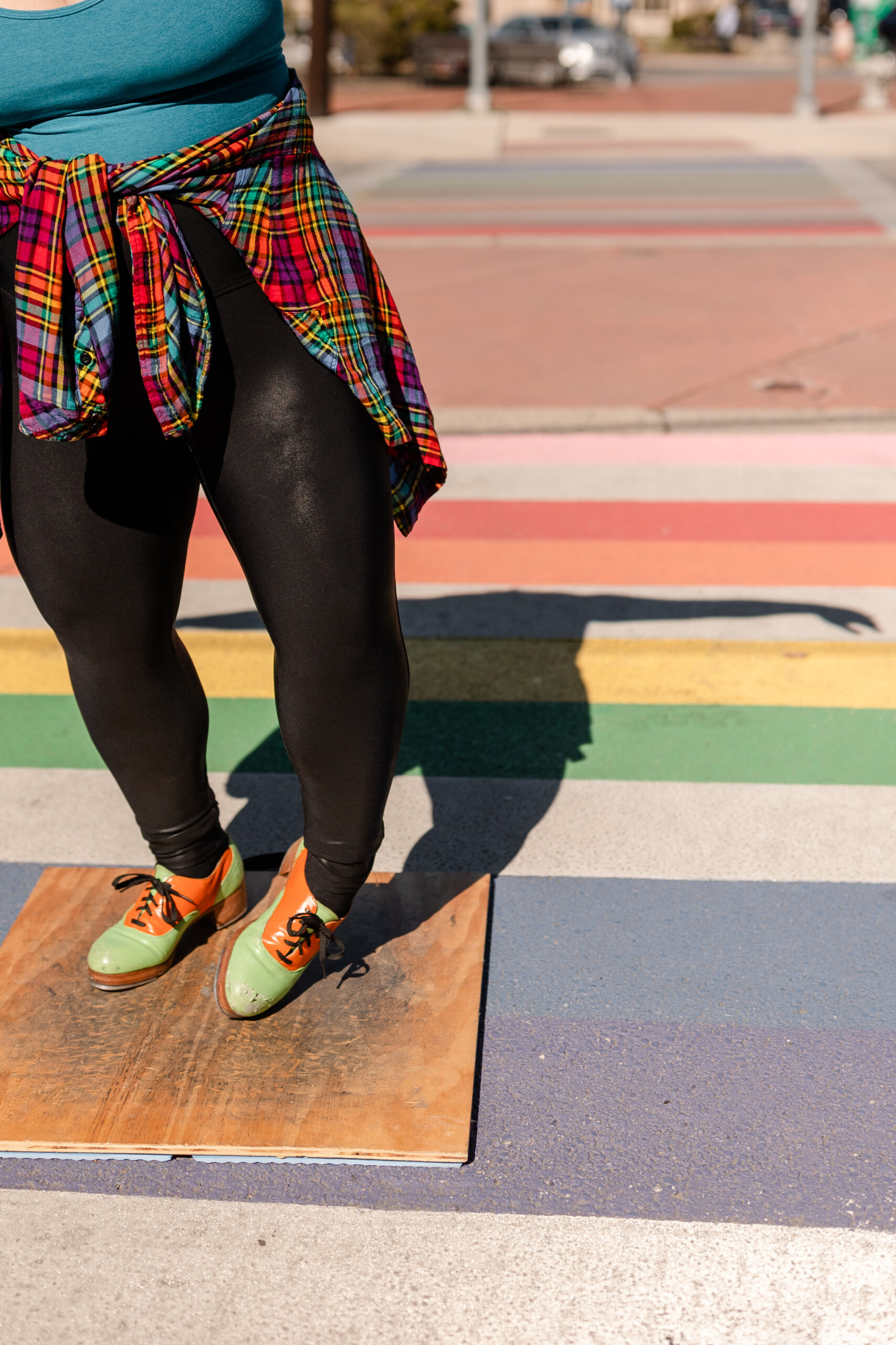 tap dancer dancing on a rainbow painted street