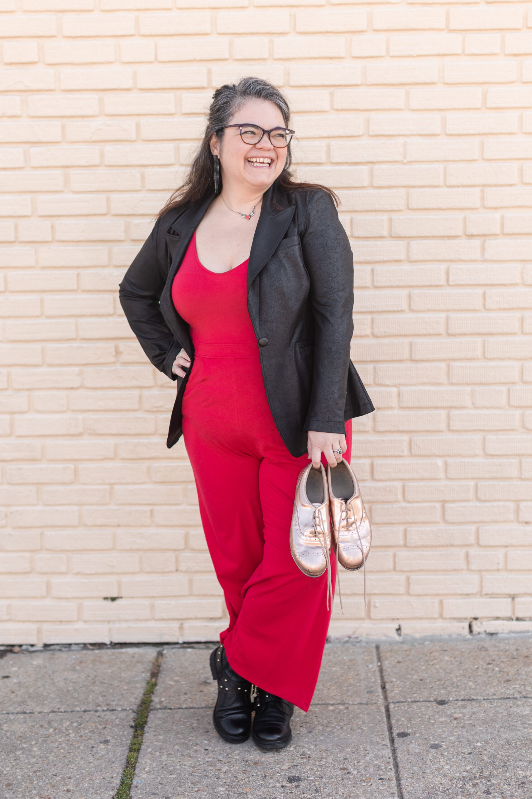 headshot of a tap educator and community leader posing with her tap shoes